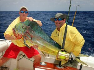 Two anglers holding a large Mahi caught offshore near Amelia Island, Florida with Pipe Dream Charters