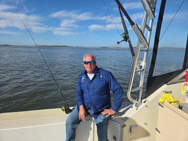 Captain Scott Thompson setting on back of the Pipe Dream 3 fishing charter boat in Amelia Island.