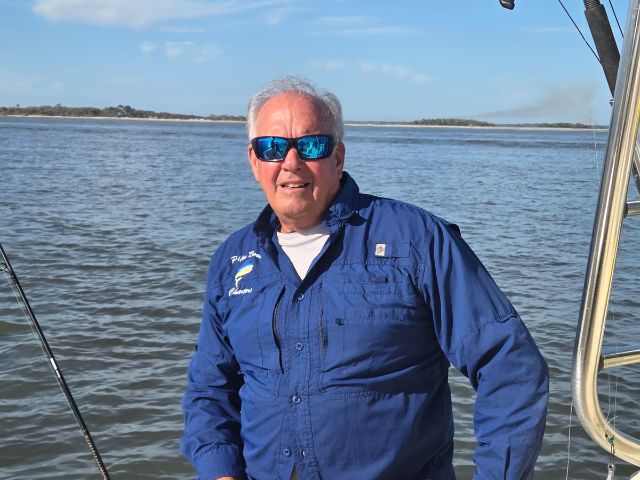 Captain Scott Thompson, sitting on the back of Pipe Dream Charters Boat.