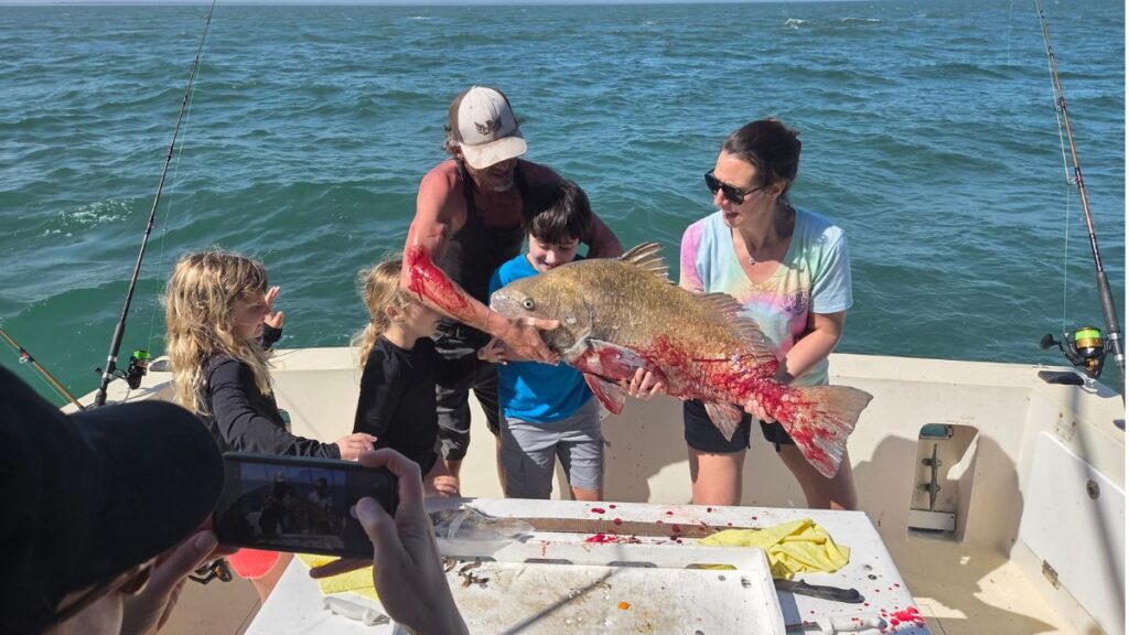 A guest holding a blackdrum caught at the Fort Clinch State Park Jetty on Amelia Island, Florida — a Pipe Dream Charters 4-hour private jetty fishing charter aboard Pipe Dream III departing from Fernandina Harbor Marina.